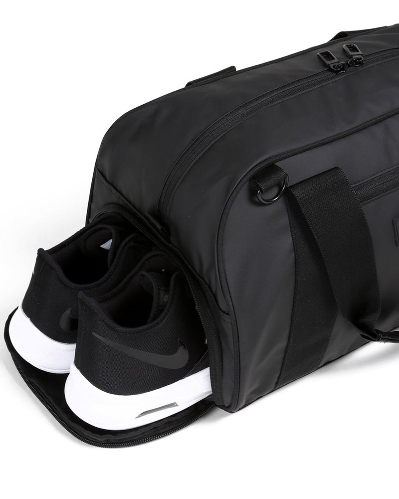 Side view of matte black burner gym duffel bag showing zip shoe compartment