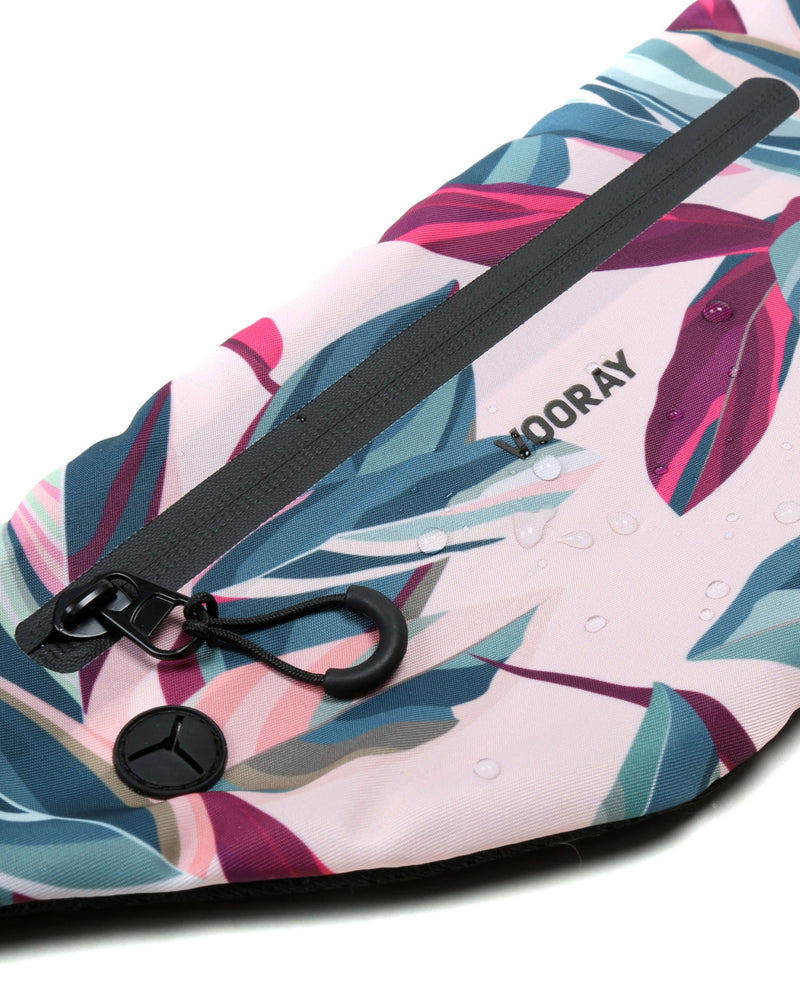 Close up view of zip and rubber headphone outlet on botanical pink active fanny pack