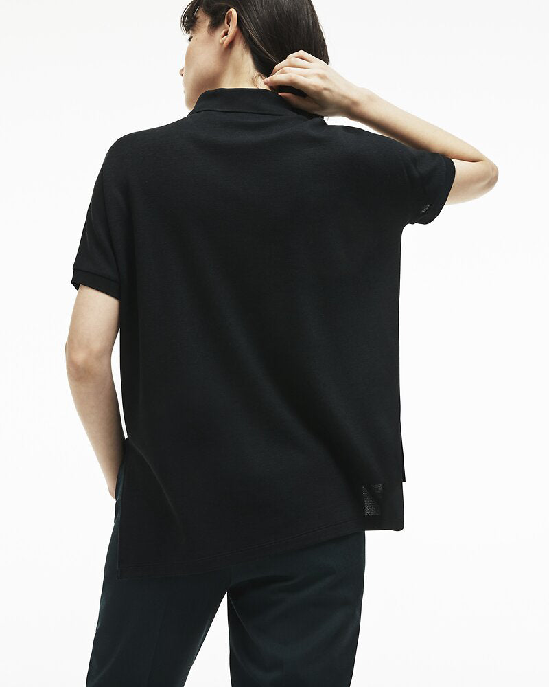 Back view of model wearing lacoste relaxed fit polo in black