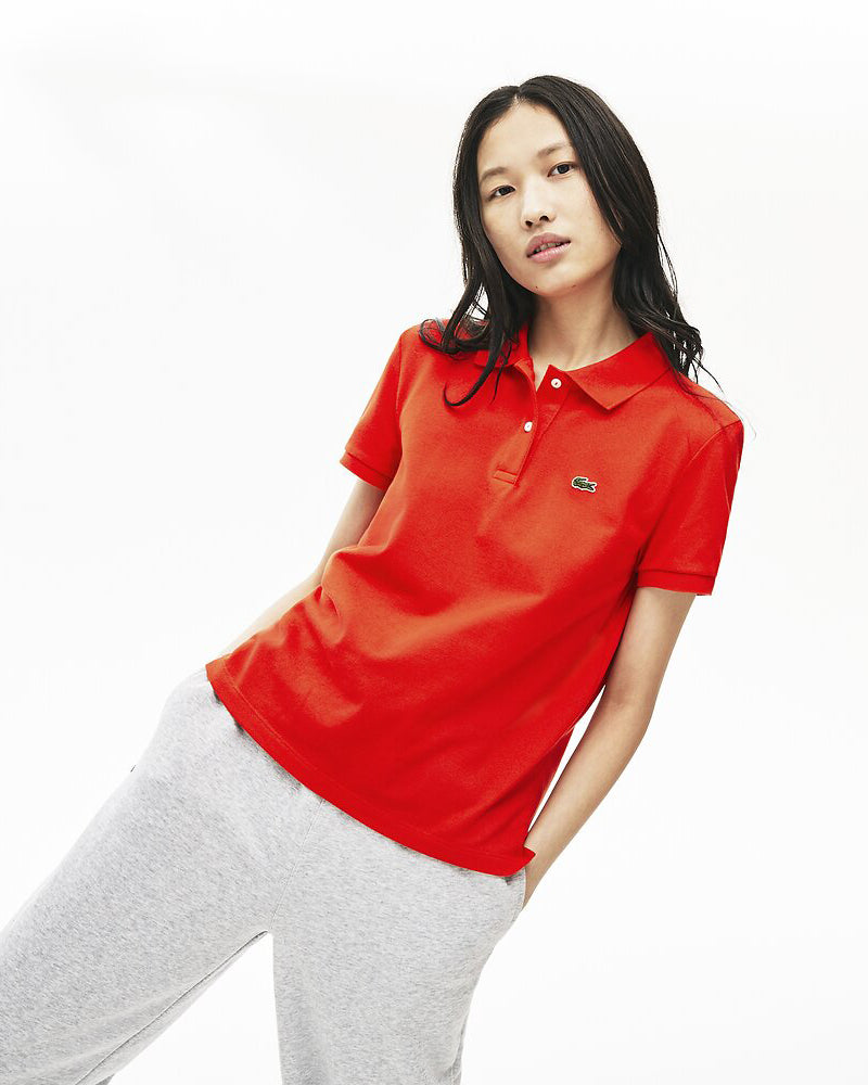 Front view of model wearing Lacsote Classic 2 button relaxed fit polo in corrid with green alligator on left chest