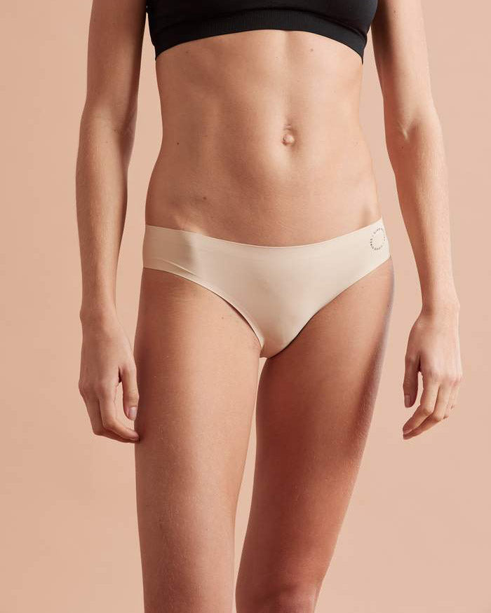 Front view of model wearing nude bikini brief