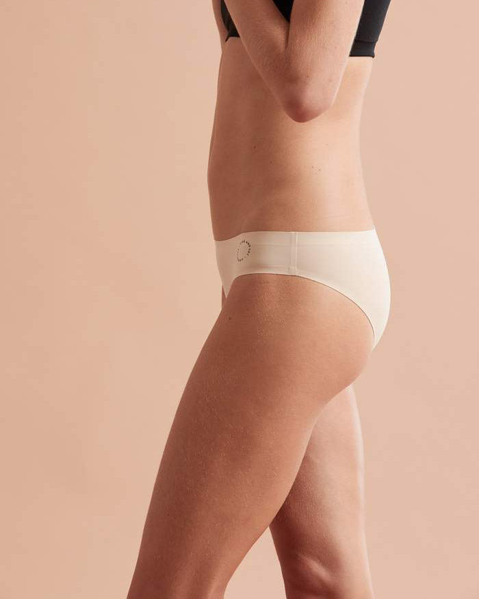 Side view of model wearing nude bikini brief