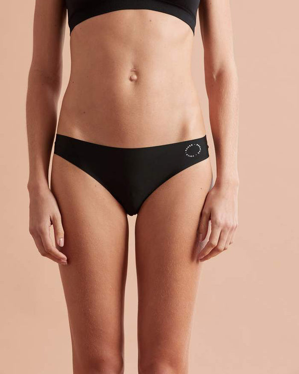 Front view of model wearing black bikini briefs